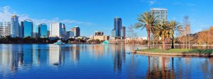 Orlando, Florida skyline by a lake, a bustling city full of businesses that need search engine optimization.