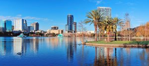Orlando, Florida skyline by a lake, a bustling city full of businesses that need search engine optimization.